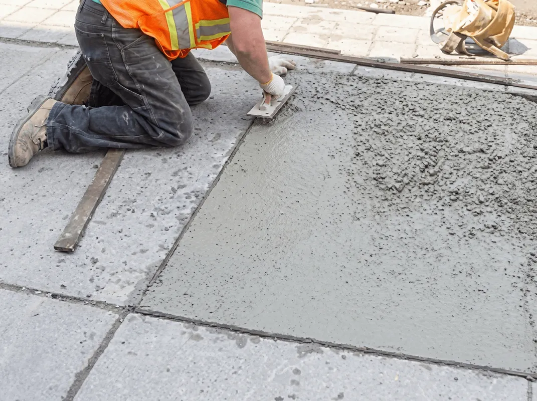 Professional repairing a concrete floor in Rochester, NY